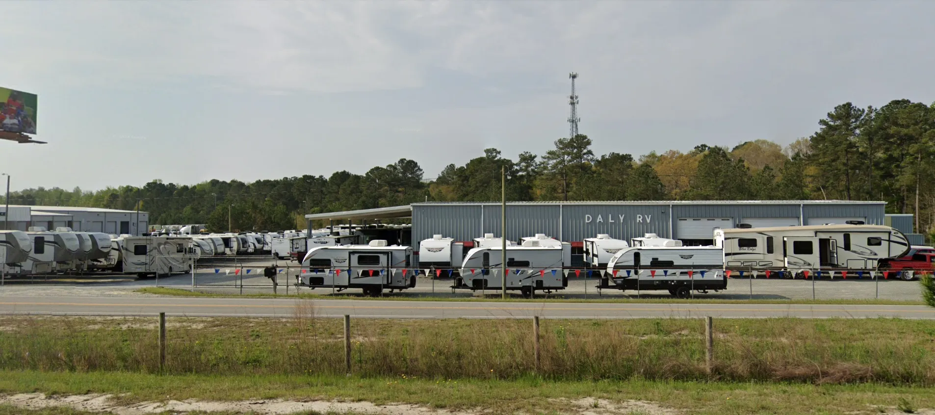 RV dealership with travel trailers displayed outdoors