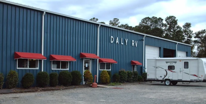 RV dealership building with a travel trailer outside
