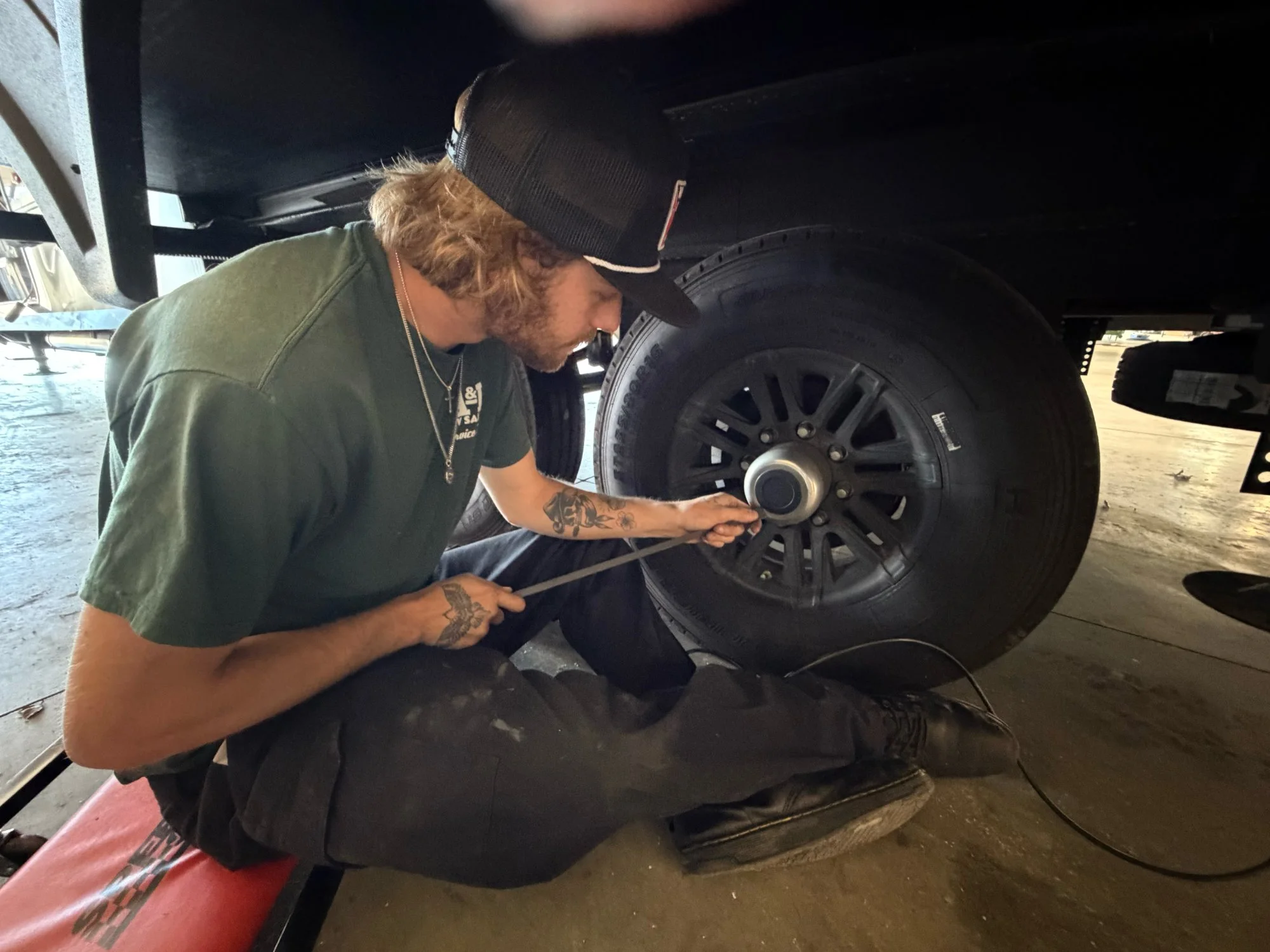 Technician servicing an RV wheel bearing